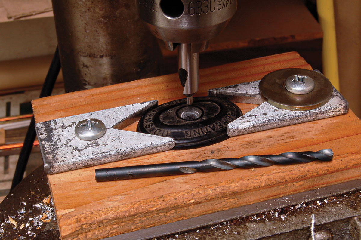 After locating, the screw hole is drilled using a standard twist drill and countersink.